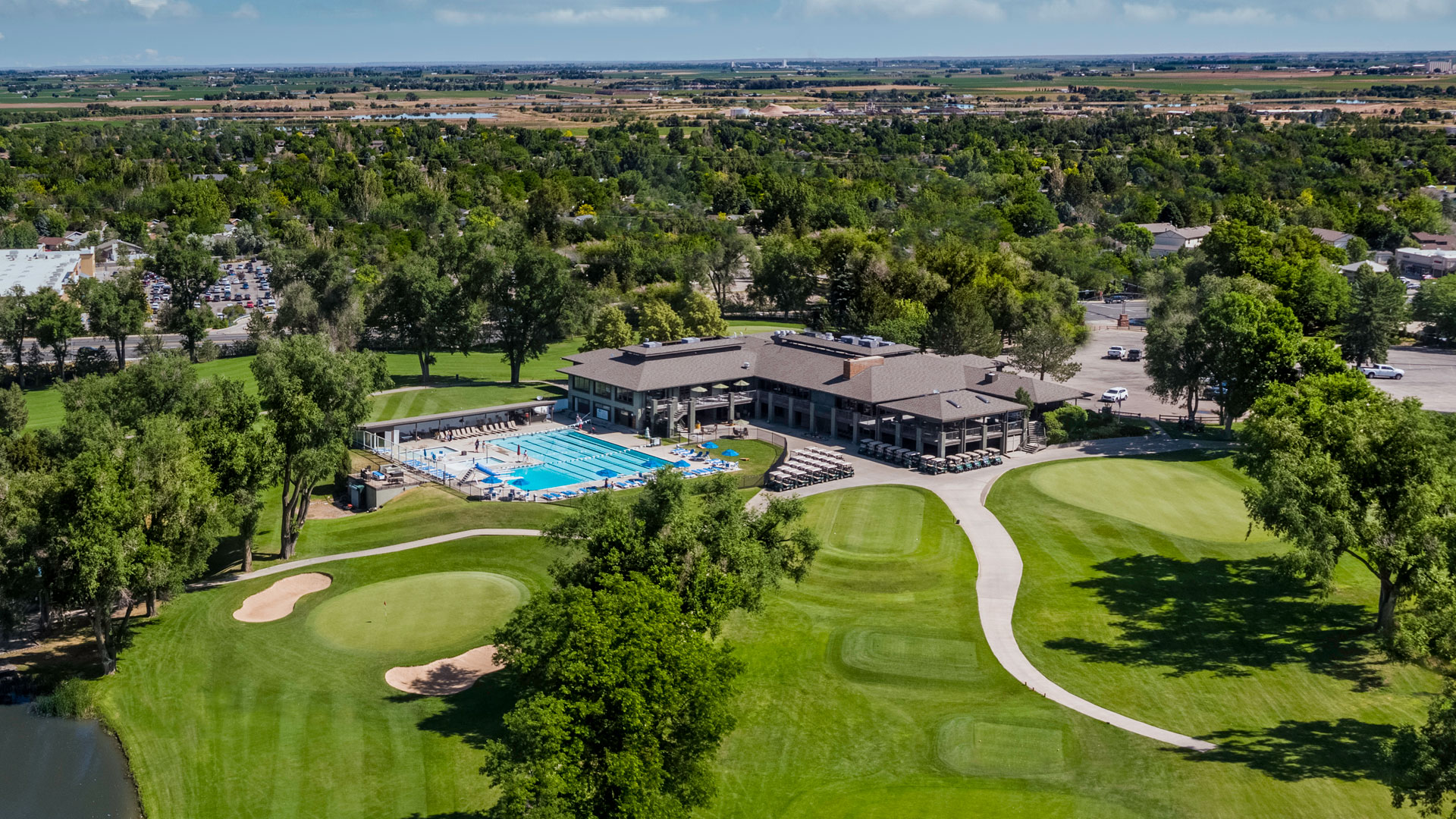 alt="Aerial view of Greeley Country Club clubhouse, pool, and golf course grounds in Greeley, Colorado"