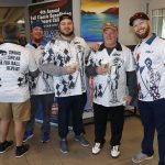 group of golfers wearing the same shirt posing before a charity golf tournament in colorado
