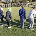 a group of 100 golfers attempting the chaos putt at the 5th annual fall classic charity golf tournament in colorado