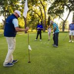 a golf pro, golfers, all putting on a green in buffalo wyoming