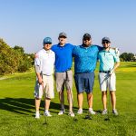 team of golfers on a fairway during a charity golf tournament in Colorado