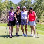 Four female golfers on the green during a charity golf touranment in Colorado