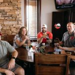 group of golfers around a table during the ceremony of a charity golf tournament in colorado