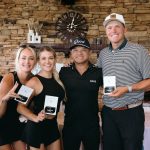 a group of winners holding up their trophies during the ceremony of the charity golf tournament in colorado
