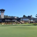putting green with clubhouse in the background