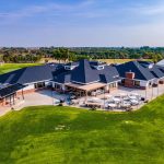 aerial view of clubhouse and golf carts