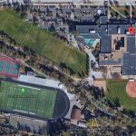 over top view of football field and city buildings