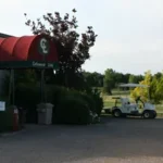 building awning on right with golf cart and parking lot