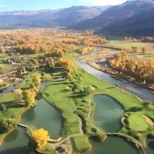 Aerial view of Dalton Ranch Golf Club's fairways along the Animas Valley with red cliffs in the background, Durango, Colorado