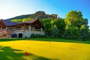 Rifle Creek Golf Course, a public golf course with two 9-hole tracks in Rifle, Colorado, set against the Hogback Ridge
